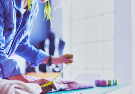 Fashion designer woman working on her designs in the studioの写真素材