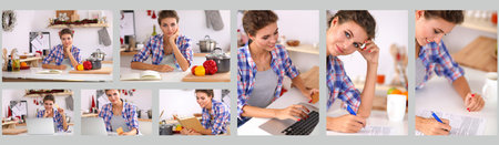 Smiling woman online shopping using computer and credit card in kitchenの写真素材
