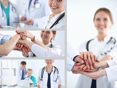 Beautiful young smiling female doctor sitting at the deskの写真素材