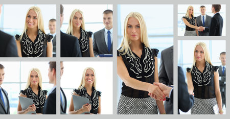 Business woman standing in foreground in officeの写真素材