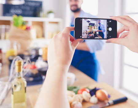 Portrait of handsome man filming cooking show or blogの写真素材