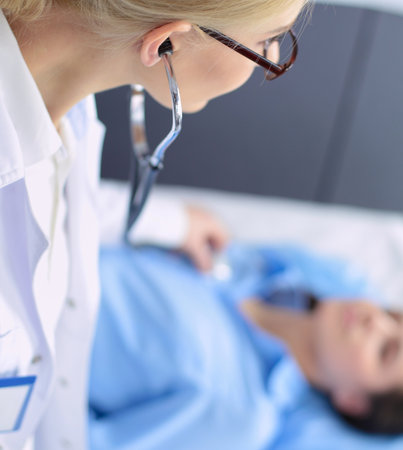 Doctor and patient discussing something while sitting at the table . Medicine and health care conceptの写真素材