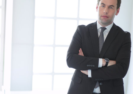 Portrait of a confident mature businessman standing outside.の写真素材