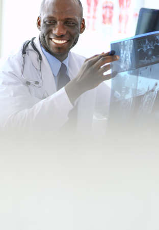 Portrait young african medical doctor holding patients x-rayの写真素材