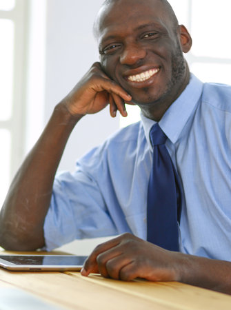 African american businessman on headset working on his laptopの写真素材