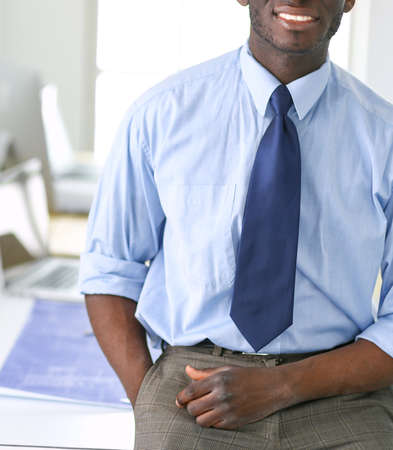 Portrait of an handsome black businessman standing in officeの写真素材
