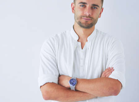 Young business man standing isolated on white background.の写真素材