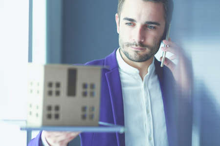Portrait of young designer in front of laptop and computer while working.の写真素材