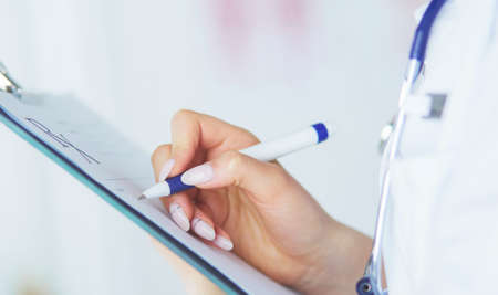 Female doctor holds blank prescription document. office Hospitalの写真素材