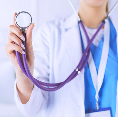 Smiling medical doctor woman with stethoscope in hospitalの写真素材