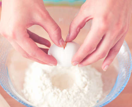 Woman is making cakes in the kitchenの写真素材