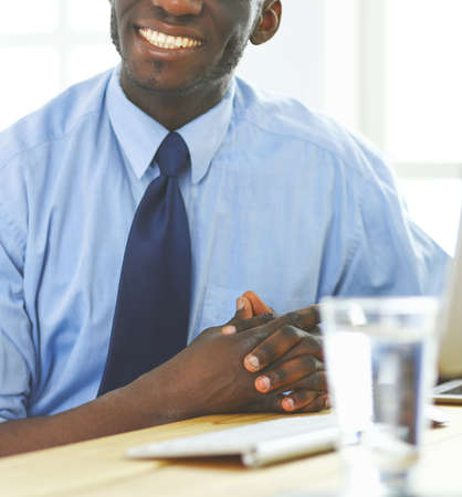 African american businessman on headset working on his laptopの写真素材