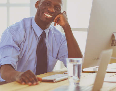 African american businessman on headset working on his laptopの写真素材