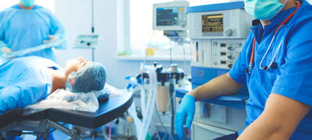 Male surgeon on background in operation roomの写真素材