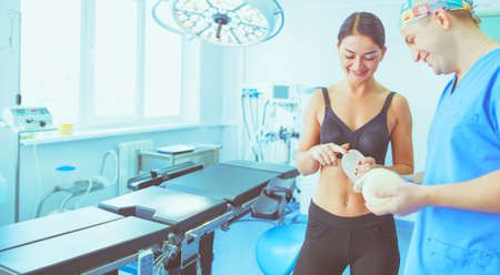 Doctor showing young patient her chest in his office at the hospitalの写真素材