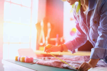 Fashion designer woman working on her designs in the studio