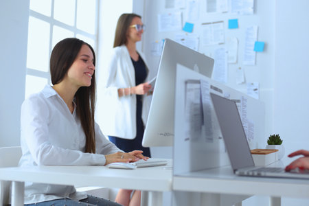 Attractive business woman working on laptop at office. Business peopleの写真素材