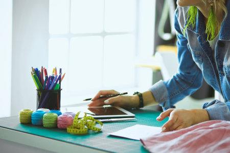 Fashion designer woman working on her designs in the studioの写真素材