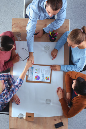 Business people sitting and discussing at meeting, in officeの写真素材