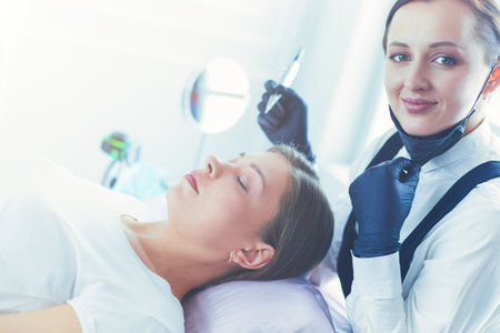 Microblading eyebrows work flow in a beauty salon.の写真素材