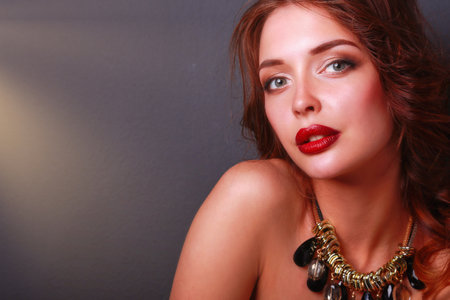Beautiful woman with evening make-up in black dressの写真素材