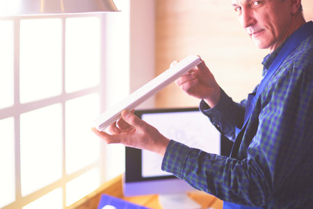 Architect working on drawing table in officeの写真素材