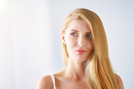 Portrait of beautiful woman isolated on gray backgroundの写真素材