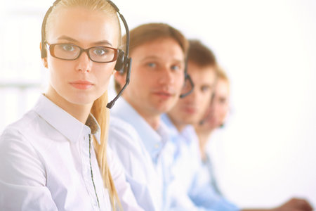 Attractive positive young businesspeople and colleagues in a call center officeの写真素材