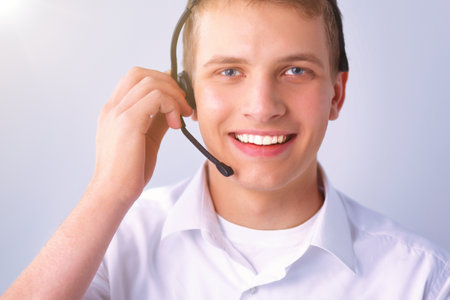Customer support operator with a headset on white backgroundの写真素材