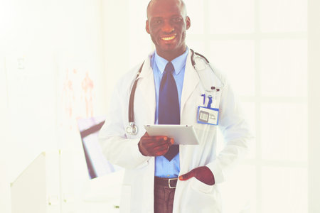 Portrait young african medical doctor holding patients x-rayの写真素材
