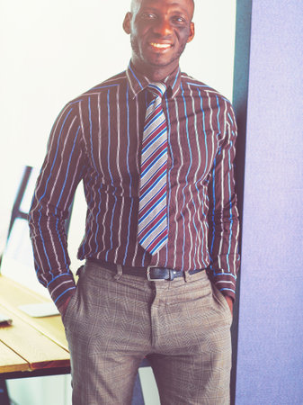 Portrait of an handsome black businessman standing in officeの写真素材