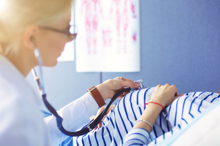 Doctor and patient discussing something while sitting at the table . Medicine and health care conceptの写真素材