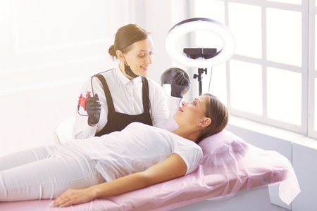 Microblading eyebrows work flow in a beauty salon.の写真素材