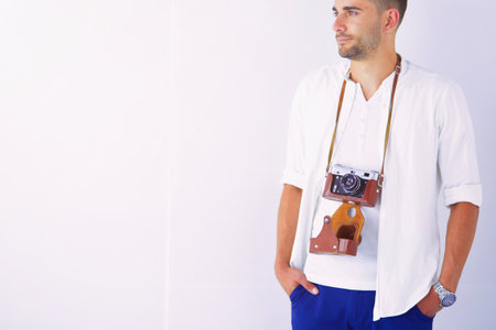 Young man with camera. Isolated over white background.の写真素材
