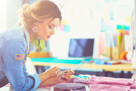 Fashion designer woman working with her designs in the studioの写真素材