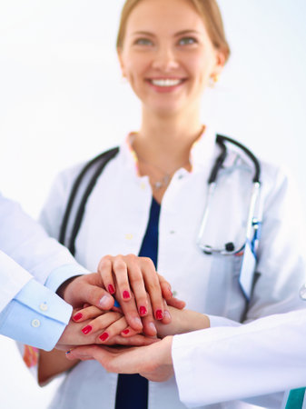 Doctors and nurses in a medical team stacking handsの写真素材