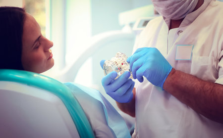 Dentist and his assistant carrying out a thorough examinationの写真素材