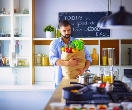 Man preparing delicious and healthy food in the home kitchenの写真素材