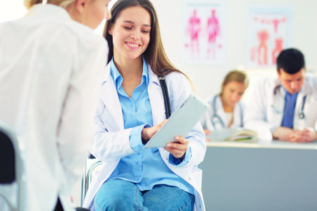 Doctor and patient discussing something while sitting at the table . Medicine and health care conceptの写真素材