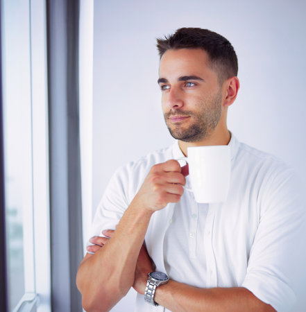 Young business man standing isolated on white background.の写真素材