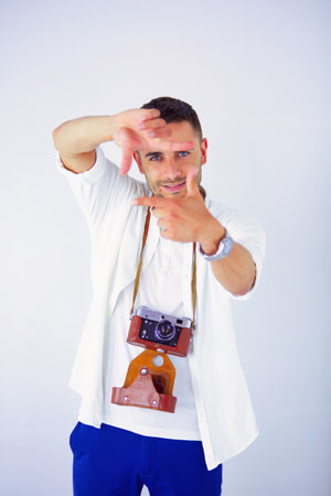 Young man with camera. Isolated over white background.の写真素材