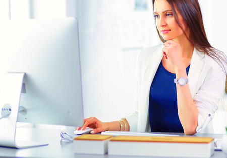 Attractive business woman working on laptop at office. Business peopleの写真素材