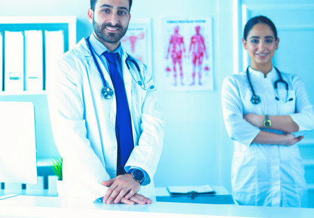 Attractive male doctor in front of medical groupの写真素材
