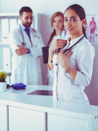 Attractive female doctor in front of medical groupの写真素材