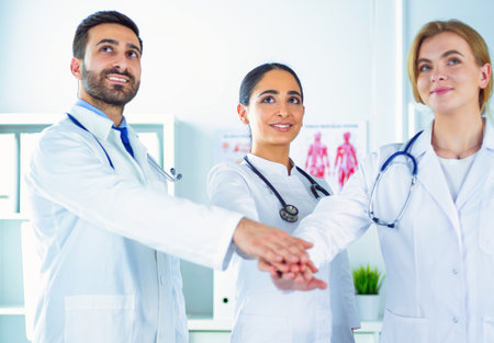 Doctors and nurses coordinate hands. Concept Teamwork in hospital for success work and trust in teamの写真素材