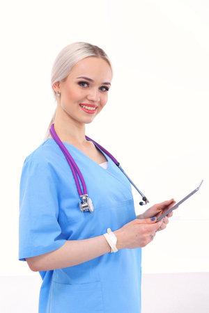 Female doctor using a digital tablet and standing on white background. Woman doctors.の写真素材