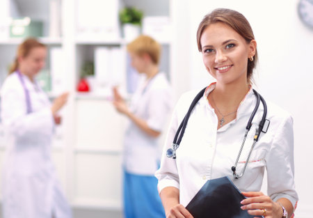 Smiling medical doctor woman with stethoscope in hospitalの写真素材