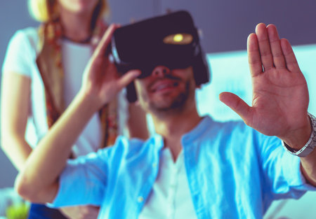 Young male software programmer testing a new app with 3d virtual reality glasses in office.の写真素材