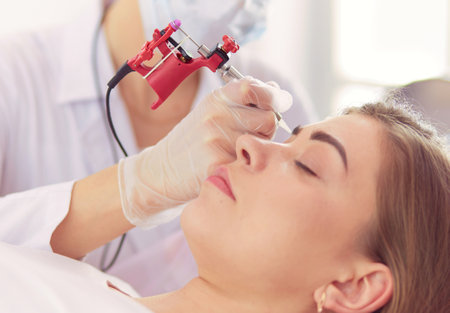 A young girl having red lips permanent makeup, micropigmentationの写真素材