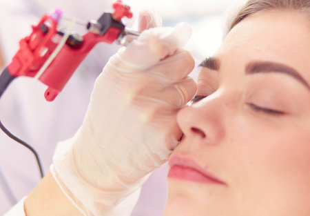 A young girl having red lips permanent makeup, micropigmentationの写真素材